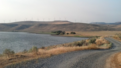 Thief Valley Reservoir with the Telocaset wind farm on the ridge. 