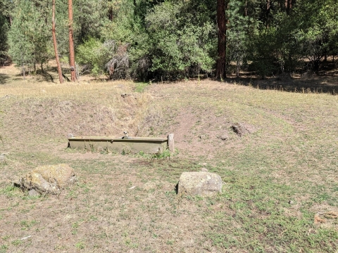 The trail starts above this water trough at Freezeout Trailhead