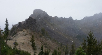 Gargoyles watching over hikers in a fall snow squall