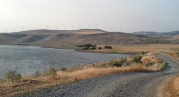 Thief Valley Reservoir with the Telocaset wind farm on the ridge. 