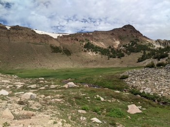 Arrive at this basin past the rock pile, with Sawtooth Peak visible on the right. 