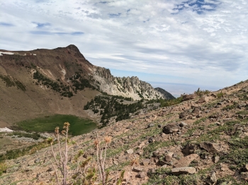 The trail comes up this ridge from the green basin below.