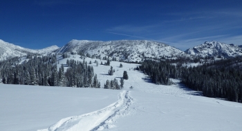 The ridge ahead is the crux of the trip. Follow it on your sled to the northern point (left in picture) and look to park there or drop off the other side. Watch of cornices.