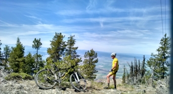 A pensive author on the summit, reminiscing of the climb.