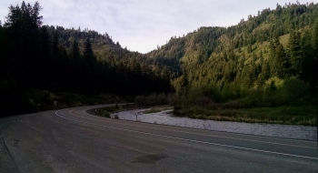 The road winds along the Wallowa River.