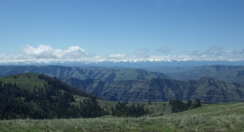 From Cayuse Flat, the ridge below can be seen where the gravel road to Buck Point and Hat Point tops out. The Wallowa Mountains are to the distance (looking west). From Cayuse Flat, the ridge below can be seen where the gravel road to Buck Point and Hat Point tops out. The Wallowa Mountains are to the distance (looking west).
