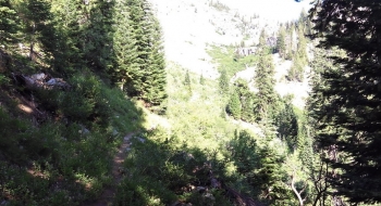 Trail climbing with waterfall on to the right.