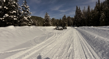 Series of switchbacks with West Eagle Meadow visible in the far distance.